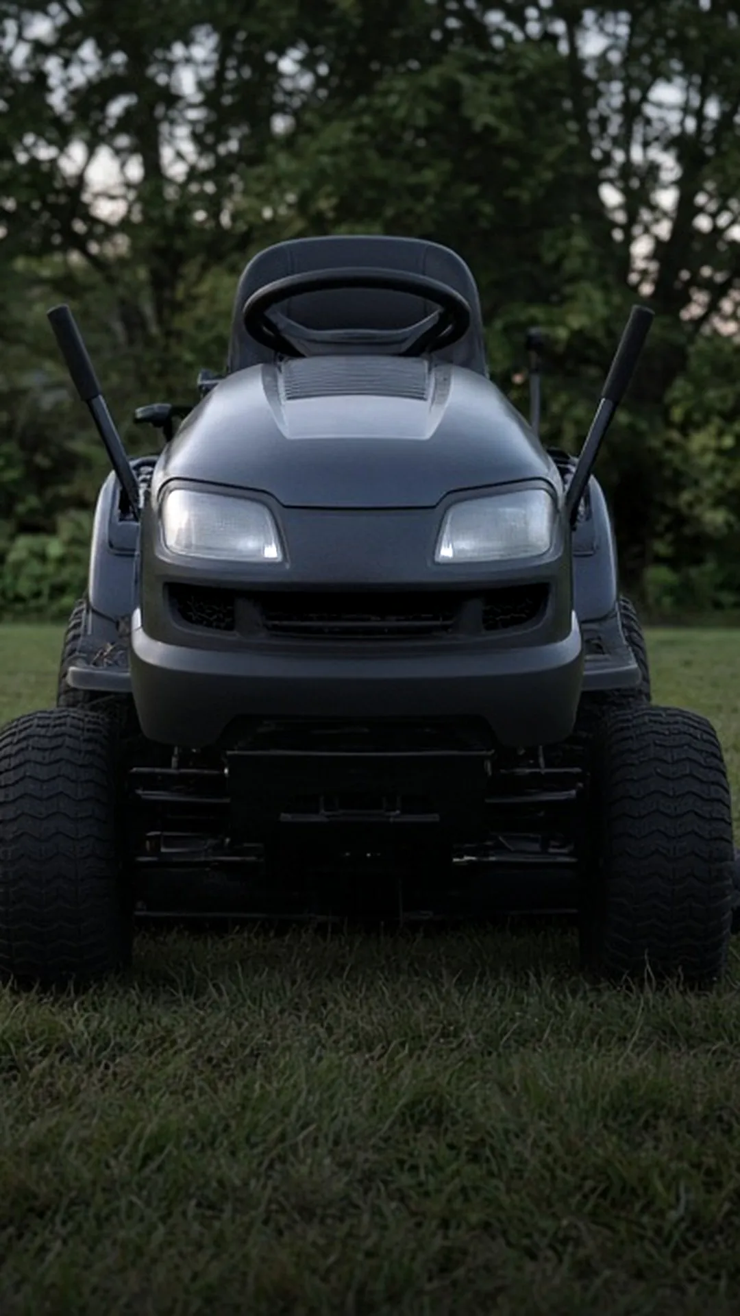 A riding mower parked on level lawn with an empty seat